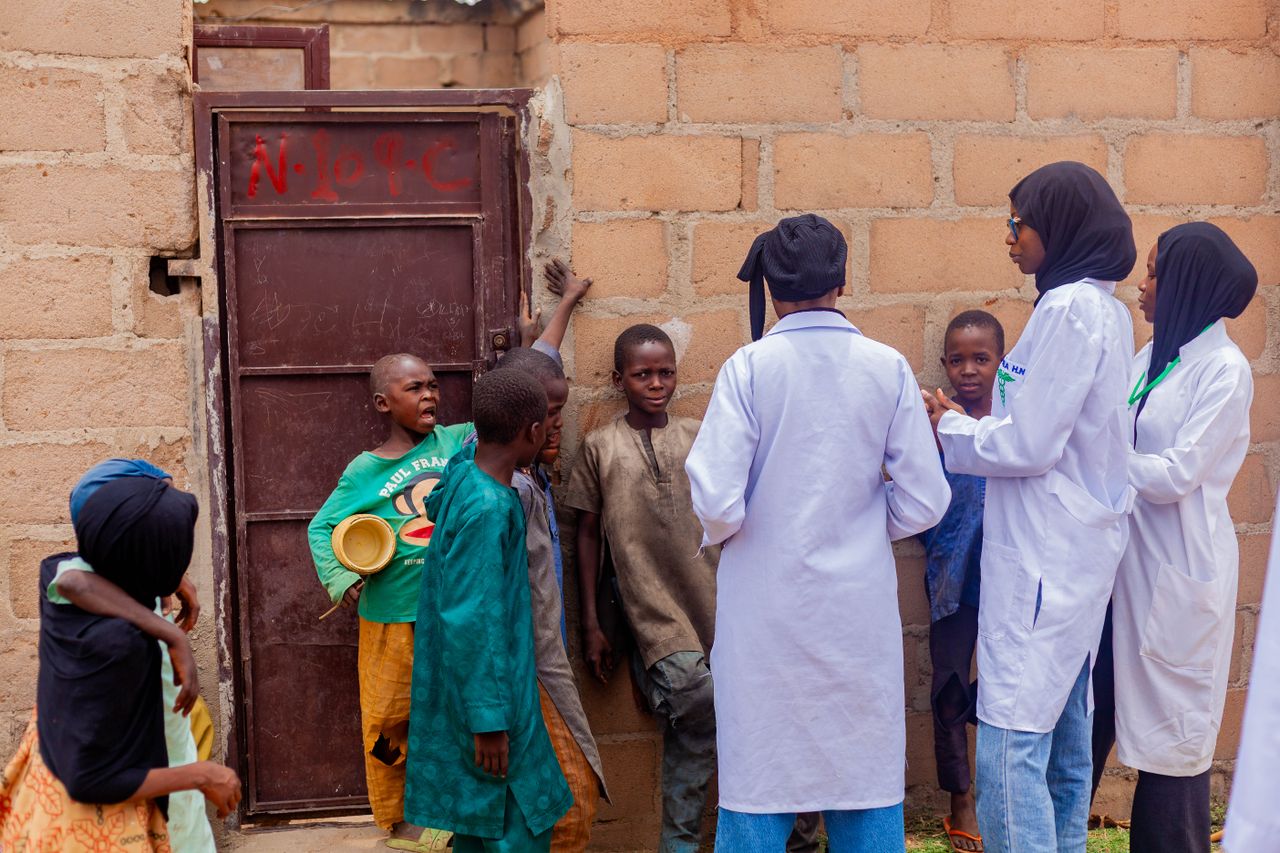 gallery-3 Healthcare workers engage with children in Gombe, Nigeria, promoting community health awareness.