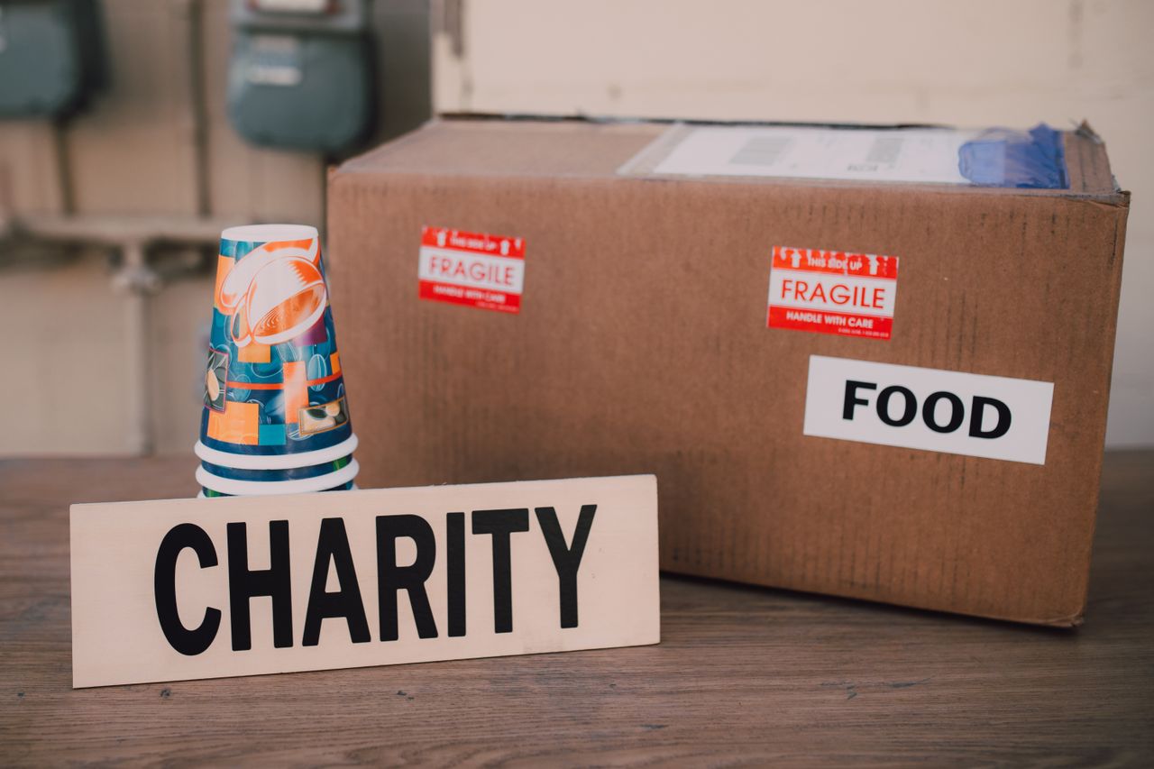 services-03 Image of a charity donation box filled with food supplies and paper cups.